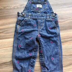 OshKosh B'gosh blue denim overalls with pink heart embroidery